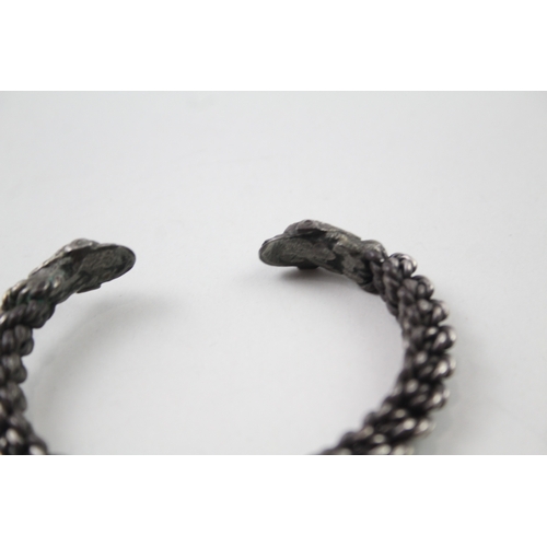 397 - Silver vintage bangle with stylised dolphin torque ends (49g)