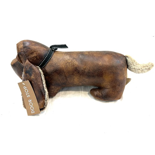 59 - Lesser and Pavey novelty dog door stop measures approx 6 inches tall by 17 inches wide