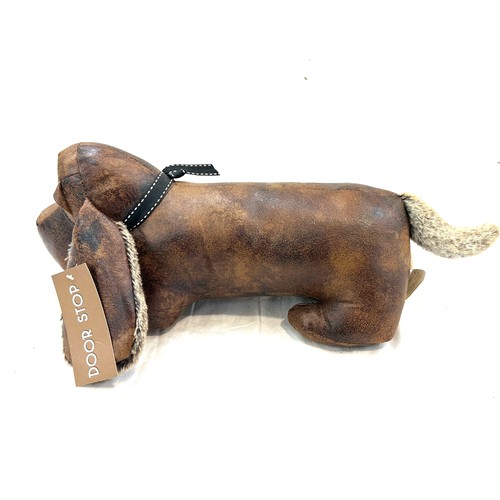 59 - Lesser and Pavey novelty dog door stop measures approx 6 inches tall by 17 inches wide