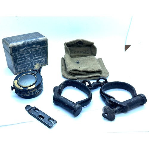 504 - Selection of collectables includes compass, hand cuffs etc