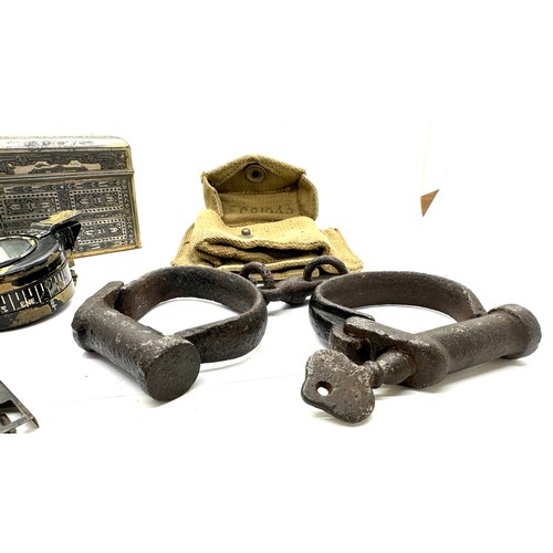 504 - Selection of collectables includes compass, hand cuffs etc