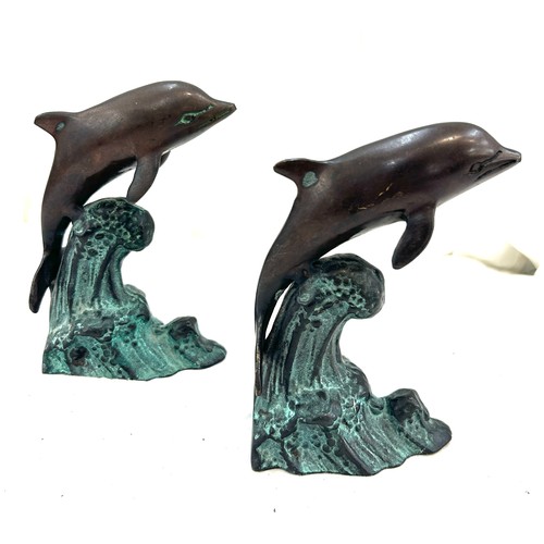120 - Two metal bronze style dolphins measures approx 7 inches tall