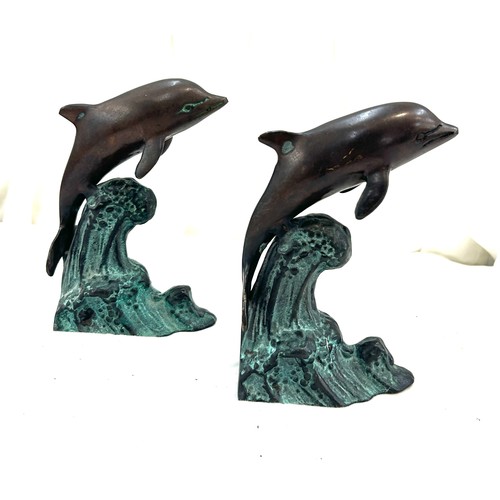 120 - Two metal bronze style dolphins measures approx 7 inches tall