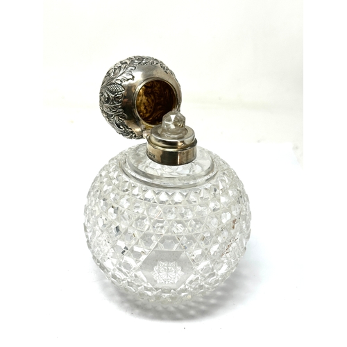 74 - Large antique silver top & cut glass perfume bottle measures approx height 15cm diameter 11cm London... 