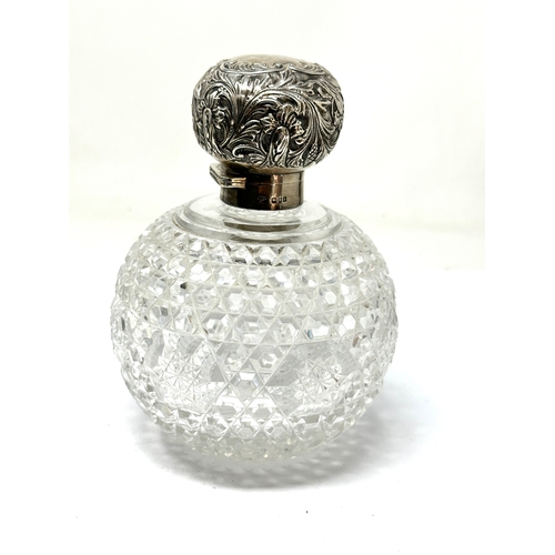 74 - Large antique silver top & cut glass perfume bottle measures approx height 15cm diameter 11cm London... 