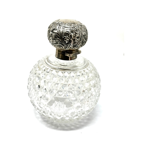 74 - Large antique silver top & cut glass perfume bottle measures approx height 15cm diameter 11cm London... 