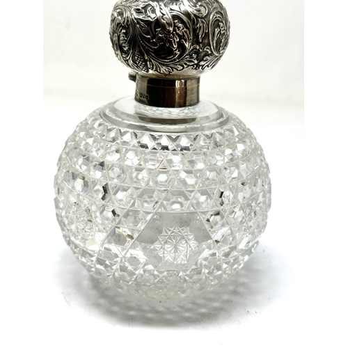 74 - Large antique silver top & cut glass perfume bottle measures approx height 15cm diameter 11cm London... 