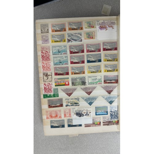 34 - Album containing various loose stamps, multiple countries, denominations