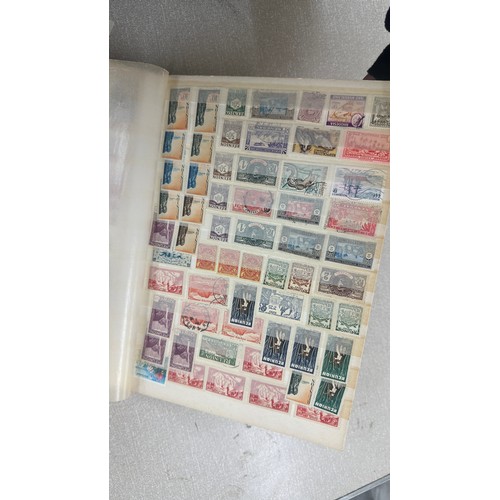 34 - Album containing various loose stamps, multiple countries, denominations