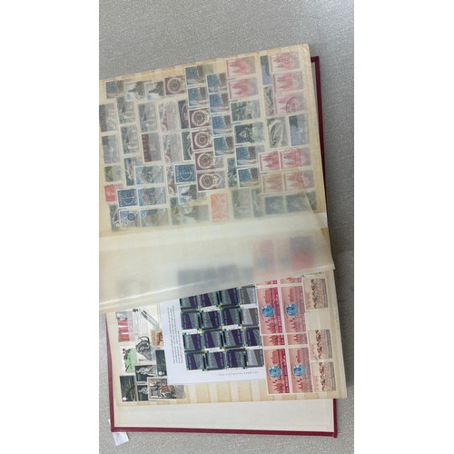 34 - Album containing various loose stamps, multiple countries, denominations