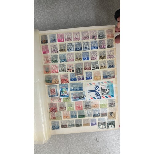 34 - Album containing various loose stamps, multiple countries, denominations