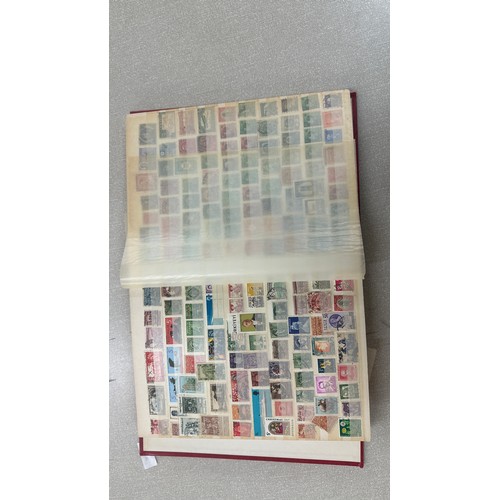 34 - Album containing various loose stamps, multiple countries, denominations