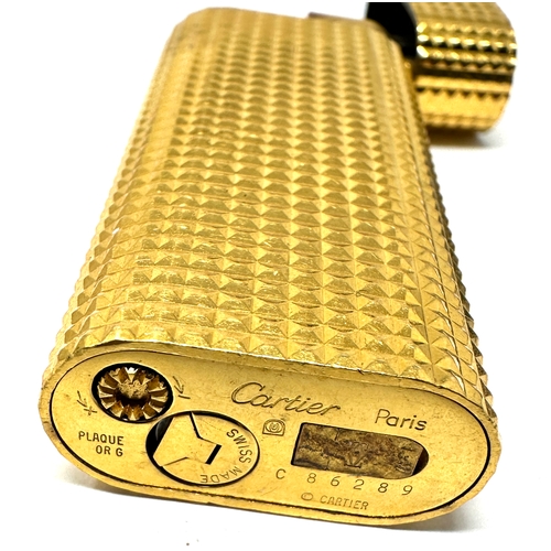 338 - Authentic Cartier Gold plated lighter.  Gold plated with a polished pyramid texture. 
2 .3'' Tall x ... 