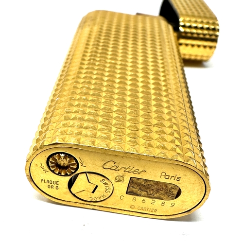 338 - Authentic Cartier Gold plated lighter.  Gold plated with a polished pyramid texture. 
2 .3'' Tall x ... 