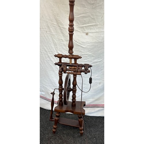 550 - Vintage wooden standard lamp with spinning wheel feature needs rewiring measures approx 62 inches ta... 