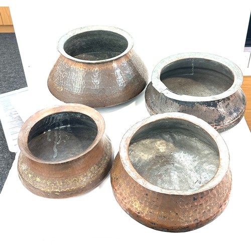 192 - Four Indian copper cooking pots largest measures approx 9 inches tall by 11 inches diameter