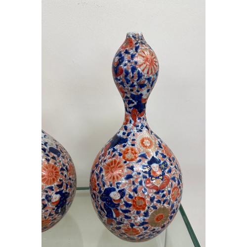 64 - Pair of unusual shaped oriental vases with marks to base overall height 12 inches