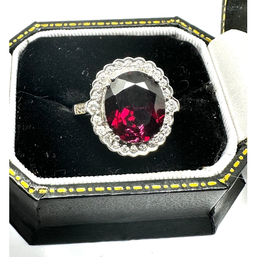 129 - 18ct white gold Garnet & Diamond ring garnet measures 12mm by 10mm with diamond halo weight 6.3g