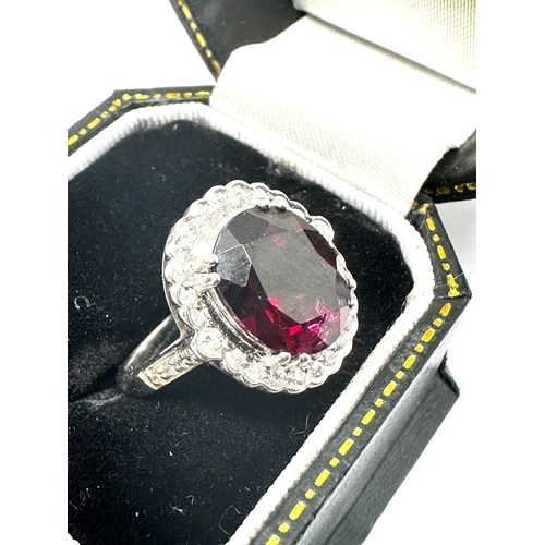 129 - 18ct white gold Garnet & Diamond ring garnet measures 12mm by 10mm with diamond halo weight 6.3g