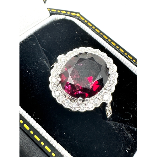 129 - 18ct white gold Garnet & Diamond ring garnet measures 12mm by 10mm with diamond halo weight 6.3g