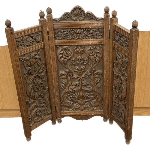 592 - Heavily carved oak fire screen measures approx 35 inches tall by 35 wide