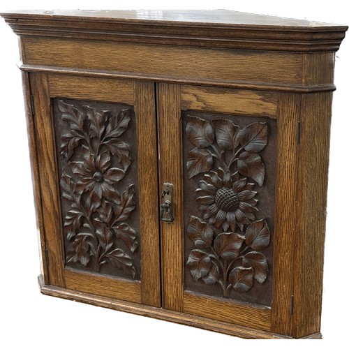 596 - Oak carved corner cabinet with key measures approx 34 inches tall by 27 wide