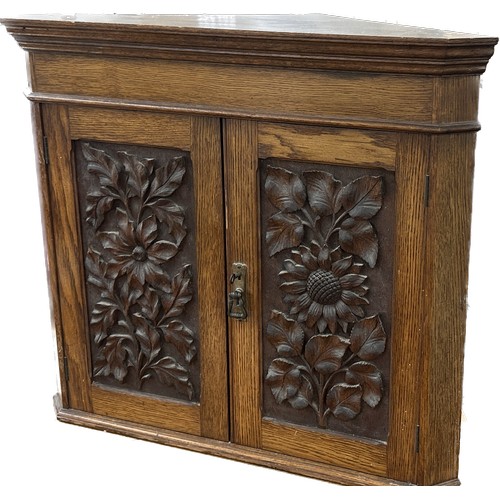 596 - Oak carved corner cabinet with key measures approx 34 inches tall by 27 wide