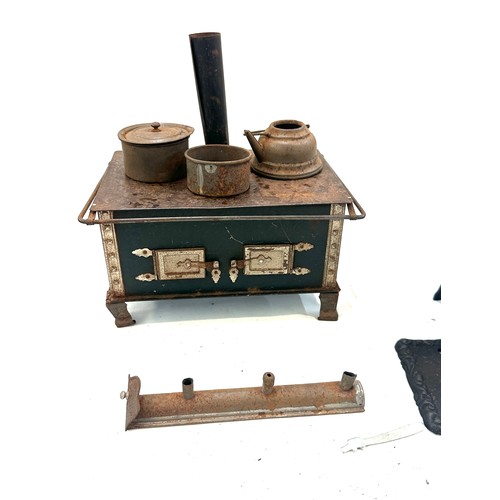 191 - Two vintage miniature cast iron stoves and accessories