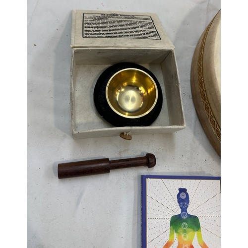 156 - Selection of meditating items to include 14' ocean drum, medium tibetan singing bowl and ' The Book ... 