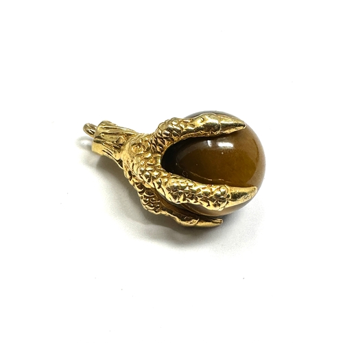 137 - 9ct gold claw & tigers eye ball pendant measures approx 2.2cm drop weight 8.5g