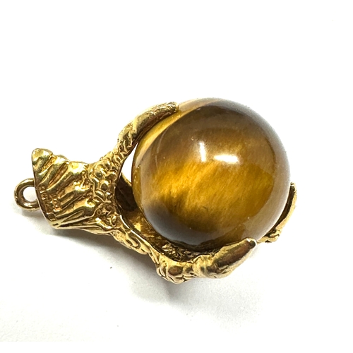 137 - 9ct gold claw & tigers eye ball pendant measures approx 2.2cm drop weight 8.5g