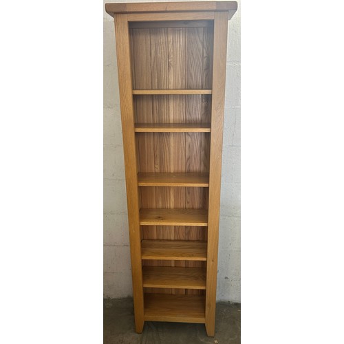 551 - Tall light oak narrow bookcase, 7 shelves, measures approximately Height 73 inches, Width 22 inches,... 