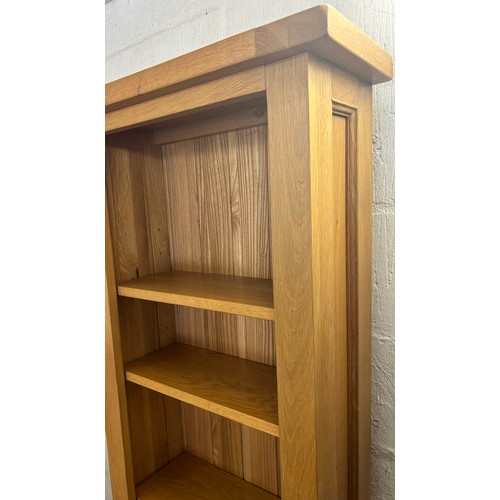 551 - Tall light oak narrow bookcase, 7 shelves, measures approximately Height 73 inches, Width 22 inches,... 