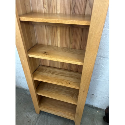 551 - Tall light oak narrow bookcase, 7 shelves, measures approximately Height 73 inches, Width 22 inches,... 