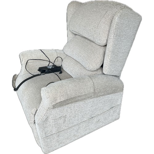 573 - Oatmeal coloured  rise and recline arm chair in working order, good overall condition