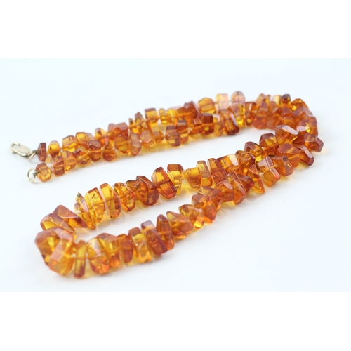 199 - 9ct gold amber necklace (22.5g)