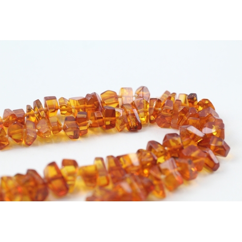 199 - 9ct gold amber necklace (22.5g)