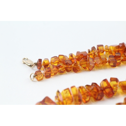 199 - 9ct gold amber necklace (22.5g)