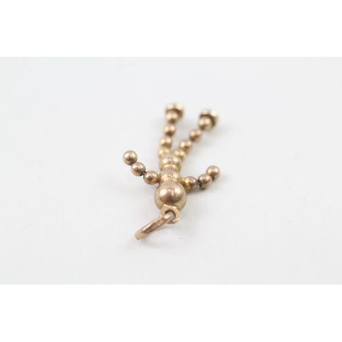 235 - 9ct gold articulated ball doll charm (1.5g)