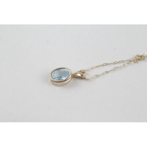 254 - 9ct gold blue topaz pendant necklace (0.7g)