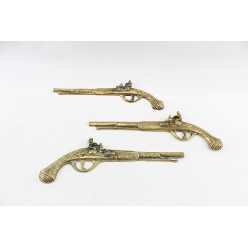 448 - Brass Ornamental Wall Pistols x 3 1050g