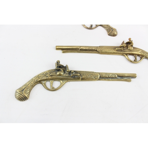 448 - Brass Ornamental Wall Pistols x 3 1050g