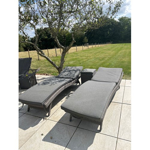 100P - 2 Outdoor rattan sun loungers and a table