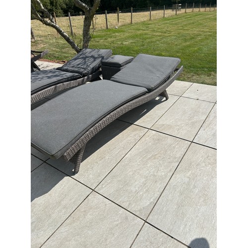 100R - 2 Outdoor rattan sun loungers and a table