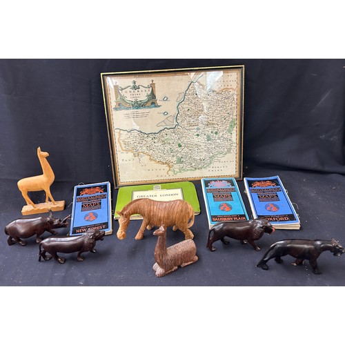 54 - Selection of maps to include Oxford, London, Somerset in frame, selection of wooden carved animals