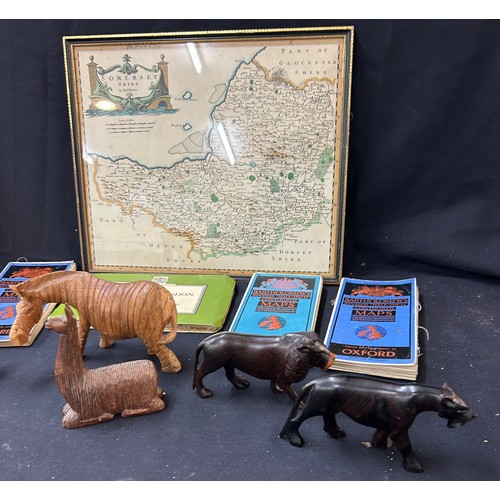 54 - Selection of maps to include Oxford, London, Somerset in frame, selection of wooden carved animals