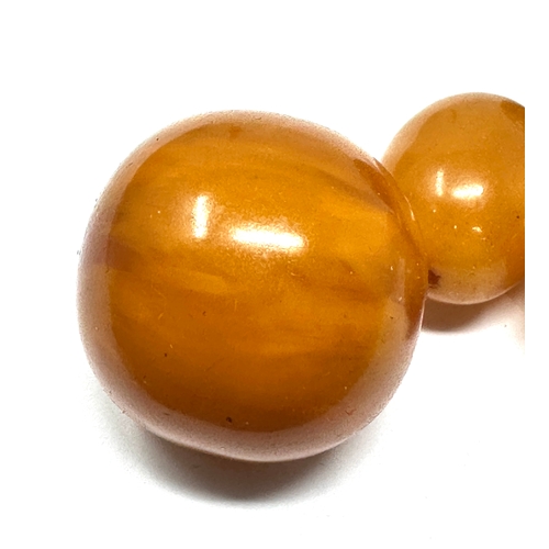 397 - Large Amber / bakelite beads weight 45.g largest bead measures approx 25mm dia