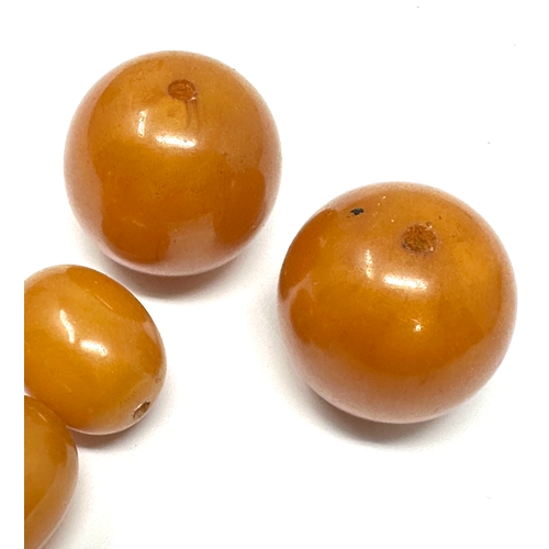 397 - Large Amber / bakelite beads weight 45.g largest bead measures approx 25mm dia