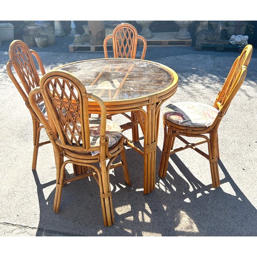 492 - Cane glass top table and 4 chairs, approximate measurements: Height 31 inches, diameter 39 inches