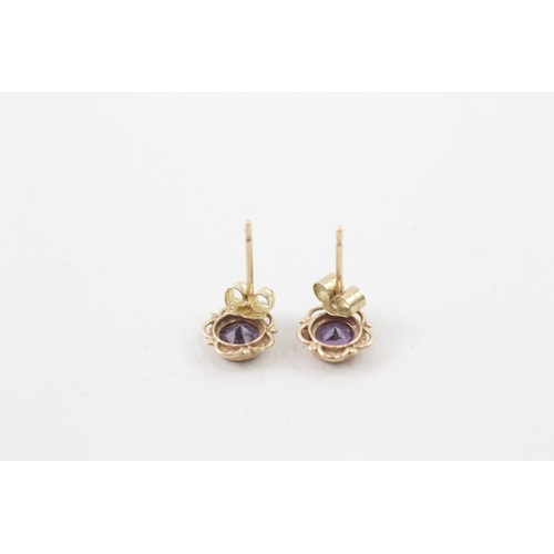 147 - 9ct gold and amethyst bezel set stud earrings (0.6g)